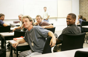 A diverse group of adult education students in class.