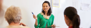 Teacher in front of students at an adult education class