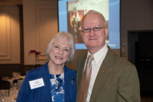 Two attendees smiling and posing together at the Literacy Matters Luncheon.