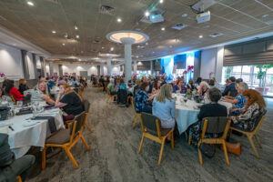 Wide view of the luncheon space with attendees gathered to celebrate literacy and community impact.