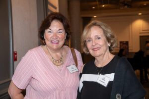 Two attendees smiling and posing together at the Literacy Matters Luncheon.