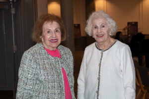 Two attendees smiling and posing together at the Literacy Matters Luncheon.