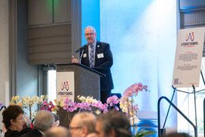 Master of Ceremonies Jeffery Kin speaking on stage during the Literacy Matters event program.