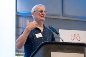 Volunteer of the Year recipient smiling on stage after receiving award at the Literacy Matters Luncheon.