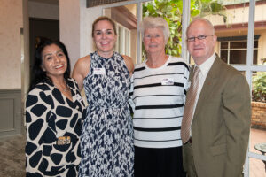 Four attendees smiling and posing together at the Literacy Matters Luncheon.
