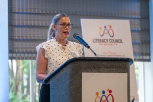 Presenter delivering remarks during the Literacy Matters Luncheon while audience listens attentively.