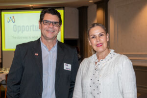 Two attendees smiling and posing together at the Literacy Matters Luncheon.