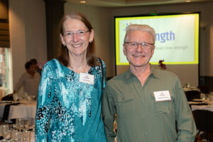 Two attendees smiling and posing together at the Literacy Matters Luncheon.
