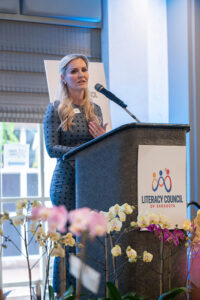 Guest speaker Jessica Muroff addressing attendees from the stage at the Literacy Matters 2026 Luncheon.