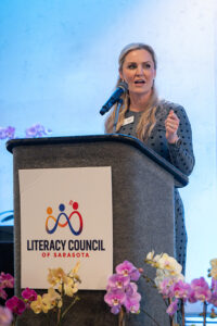 Guest speaker Jessica Muroff addressing attendees from the stage at the Literacy Matters 2026 Luncheon.