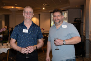 Two attendees smiling and posing together at the Literacy Matters Luncheon.