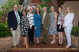 Group of attendees smiling and posing together at the Literacy Matters Luncheon.