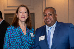Two attendees smiling and posing together at the Literacy Matters Luncheon.