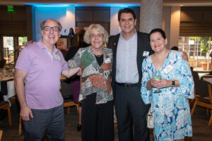 Four attendees smiling and posing together at the Literacy Matters Luncheon.