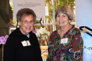Two attendees smiling and posing together at the Literacy Matters Luncheon.