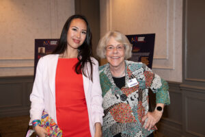 Two attendees smiling and posing together at the Literacy Matters Luncheon.