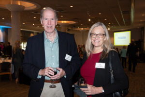 Two attendees smiling and posing together at the Literacy Matters Luncheon.