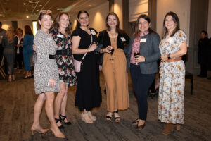 Group of attendees smiling and posing together at the Literacy Matters Luncheon.