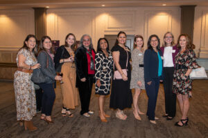 Group of attendees smiling and posing together at the Literacy Matters Luncheon.