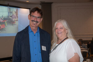 Two attendees smiling and posing together at the Literacy Matters Luncheon.