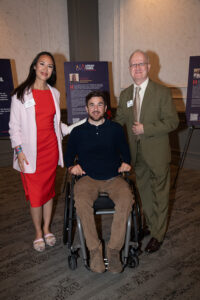 Three attendees smiling and posing together at the Literacy Matters Luncheon.