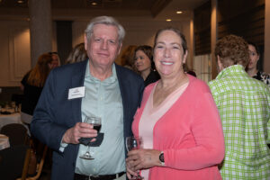 Two attendees smiling and posing together at the Literacy Matters Luncheon.