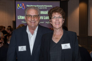 Two attendees smiling and posing together at the Literacy Matters Luncheon.