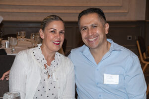 Two attendees smiling and posing together at the Literacy Matters Luncheon.
